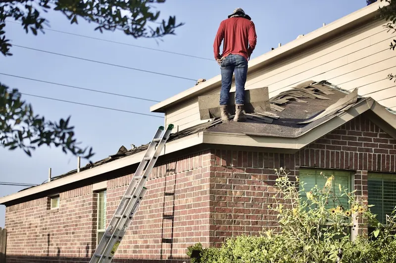 Professional roofer working on a residential roof in Country View Court